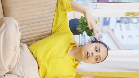 Vertical-video-of-Unwell-young-woman-watches-out-the-window-to-relax.